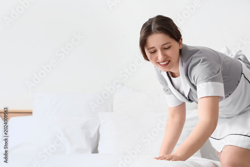 Young chambermaid making be...