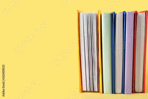 Row of colorful books on ye...
