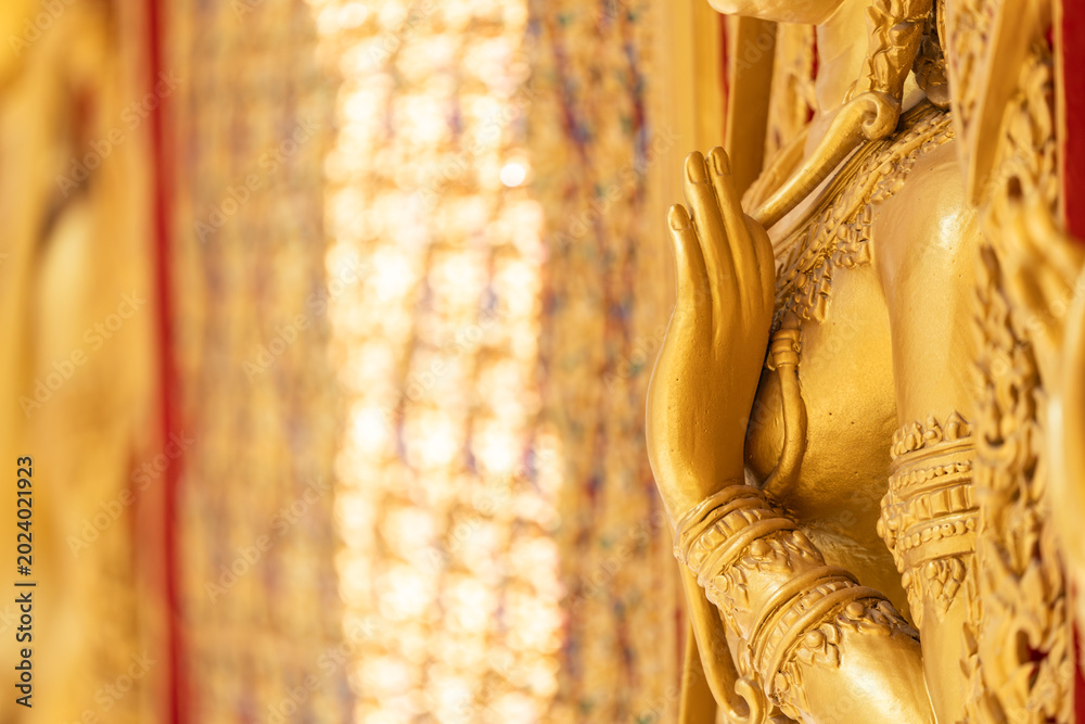 Fototapeta premium High relief guardian figure temple door Prasat Thong Kham Kanchanaphisek golden palace Wat Chantharam, ThaSung UthaiThani Thailand gilded ornament mirrored mosaic.