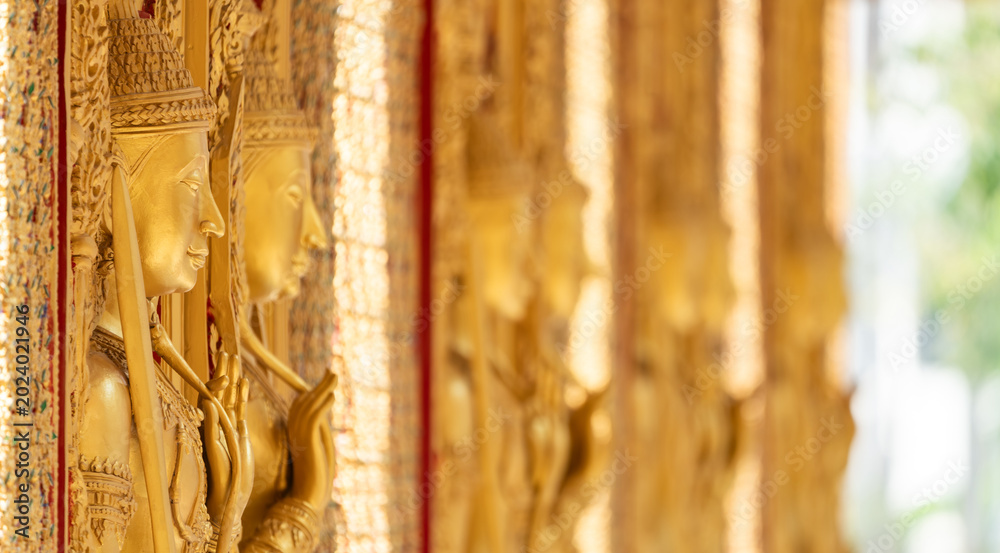 Fototapeta premium High relief guardian figure temple door Prasat Thong Kham Kanchanaphisek golden palace Wat Chantharam, ThaSung UthaiThani Thailand gilded ornament mirrored mosaic.
