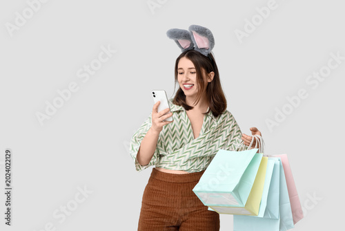 Young woman in bunny ears w...