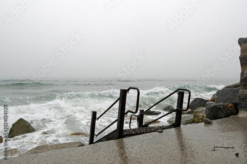 Waves crashing onto the shore on a foggy day