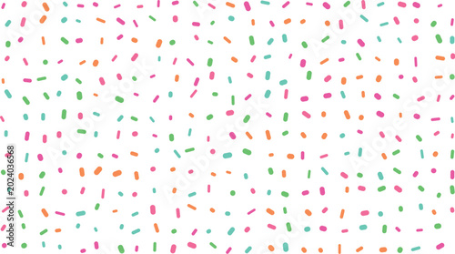 Scattered pink, green, orange, and teal sprinkles form a vibrant and playful pattern on a clean white surface