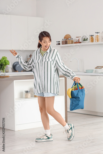 Young Asian woman holding b...
