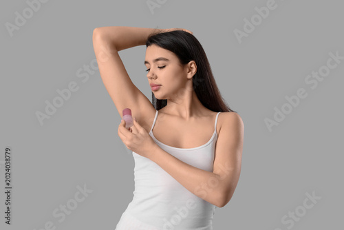 Beautiful young woman using...