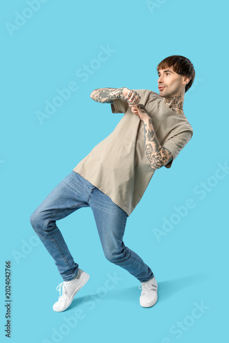 Young tattooed man dancing ...