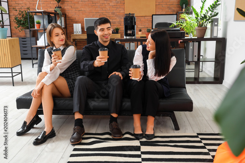 Business colleagues having coffee break in office