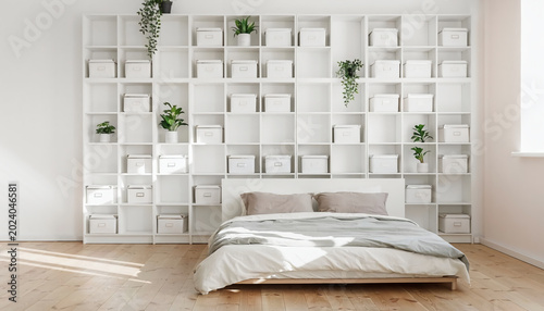 Modern Minimalist Bedroom Featuring a Large White Grid Shelving Unit with Storage Boxes and Green Plants, Bright Airy Contemporary Home Interior with Natural Sunlight on Wooden Floor
