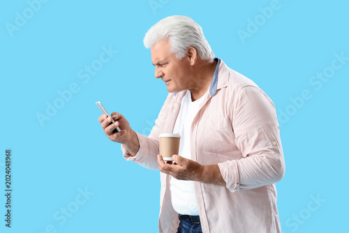 Senior man with cup of coff...