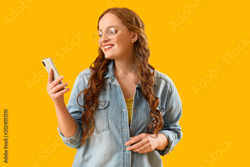 Beautiful redhead woman usi...