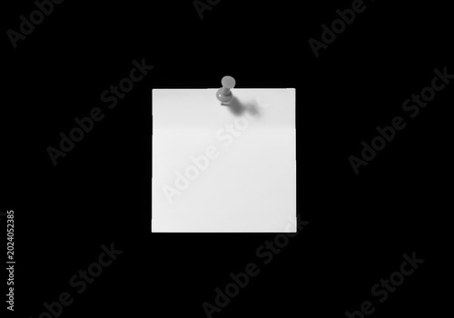 Blank sticky note pinned on black background