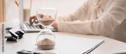 Hourglass near businesswoma...
