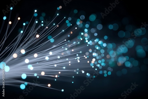 Abstract fiber optic lights glowing in the dark, creating a bokeh effect with blue and white tones. The image represents data transmission and digital connection