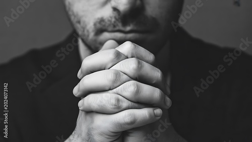 Man praying in deep faith and spiritual reflection with emotional worship and religious devotion