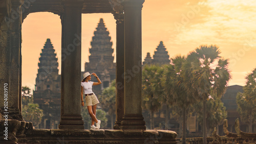 Obraz na plátně Stylish Female Tourist Admiring Angkor Wat Temple at Golden Sunrise
