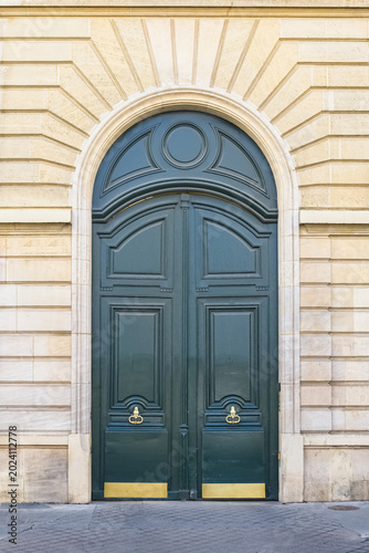 Paris, a wooden door rue de Babylone, typical building in the 7th arrondissement, a luxury district
