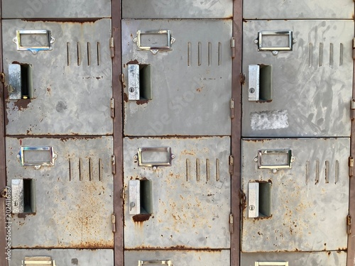 Old metal storage lockers covered in rust and left unused, using as background image.