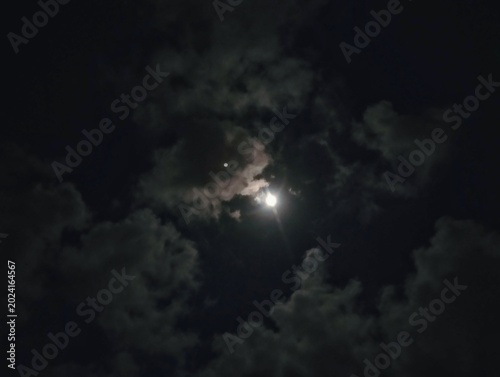 A close-up view of the Moon at night, likely captured through a telescope or with a high-zoom camera.