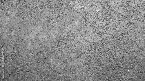 Bild auf Leinwand Rough gray asphalt surface with coarse gravel texture