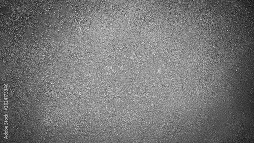 Dark grainy asphalt texture with fine aggregate surface. Uniform grain and deep tonal range give a strong, solid feel. Perfect for road, construction, or minimalist dark backgrounds.