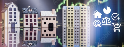 Proptech and online real estate investment concept. Miniature houses and apartment building with digital business icons and financial chart.