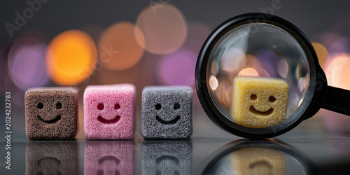 Colorful Smiley Face Foam Blocks Viewed Through a Magnifying Glass with Bokeh Lights