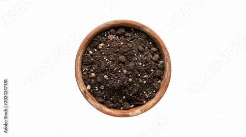 Top view of a terracotta plant pot filled with rich dark potting soil isolated on white.