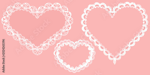Fotografie three ornate white heart shaped frames on pink background