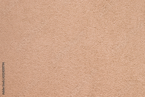Obraz na plátne Detailed rough texture of a solid concrete wall painted in warm peach tones