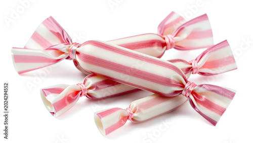 Wrapped Candies: A small pile of individually wrapped candies with pink and white stripes, hinting at a sweet and delightful treat.