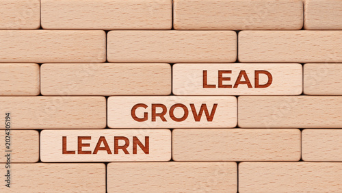 Leadership growth and learning path on wooden block steps