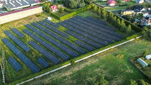Slika na platnu Aerial view of solar fields near village