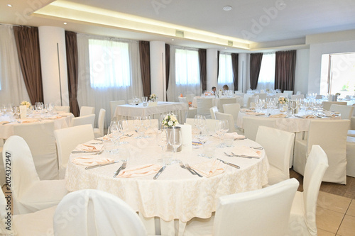 Elegant Dining Room with Round Tables and White Chair Covers