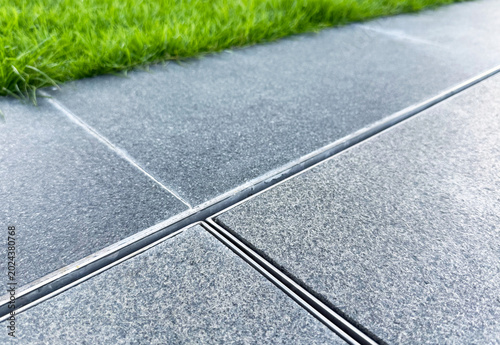Exterior tile floor with iron gutter.