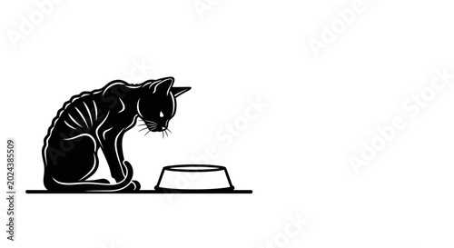 Bild auf Leinwand A skinny black cat looking at an empty food bowl.