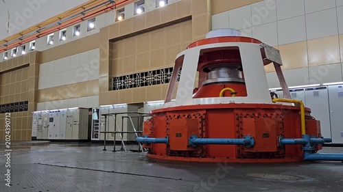 Interior of Ialy Hydroelectric Power Plant powerhouse showing large turbine generators and control panels.