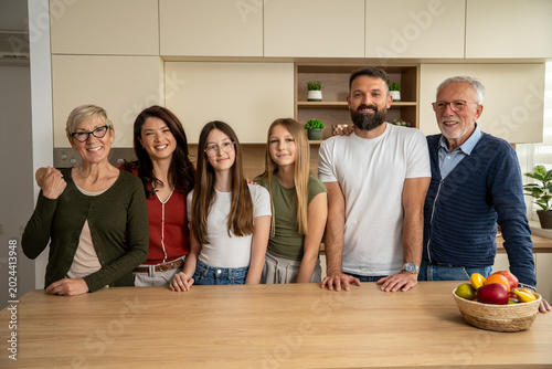 Photos Cheerful multigenerational family enjoying kitchen portrait at home