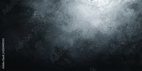 An abstract background with a grunge texture in shades of dark blue and grey, illuminated by a strong spotlight creating a dramatic and moody atmosphere.
