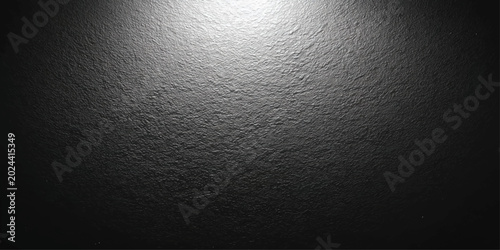 Dark textured background with a bright spotlight illuminating the upper portion, creating a dramatic and mysterious ambiance.