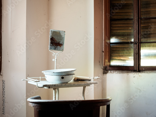 Vintage wash basin and mirror inside abandoned historic villa room