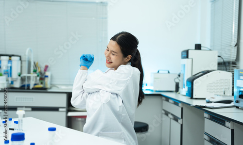 Schilderij op canvas two scientists is doing a stretchy posture due from working in research lab for too long