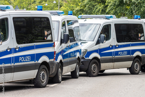 Bild auf Leinwand Police vehicles, squad buses, and motorcycles during a large-scale law enforcement operation