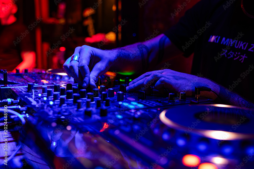 Fototapeta premium Professional dj mixer controller with lights at nightclub party close up