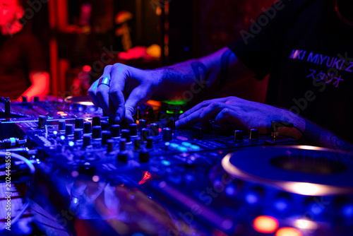 Billede på lærred Professional dj mixer controller with lights at nightclub party close up