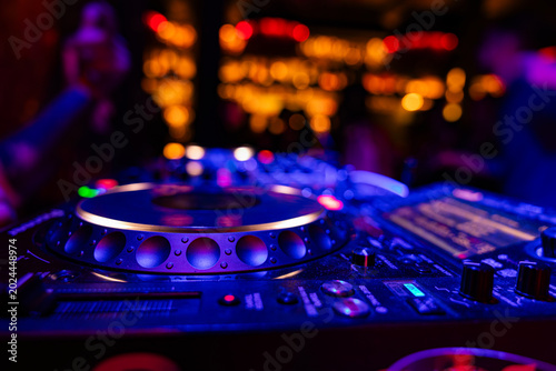 Obraz na plátně Professional dj mixer controller with lights at nightclub party close up