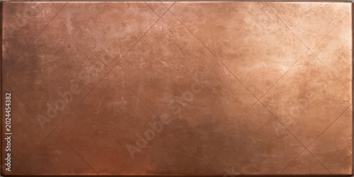 Bild auf Leinwand A close-up view of a scratched and weathered copper plate, showing a warm, metallic sheen and intricate surface details