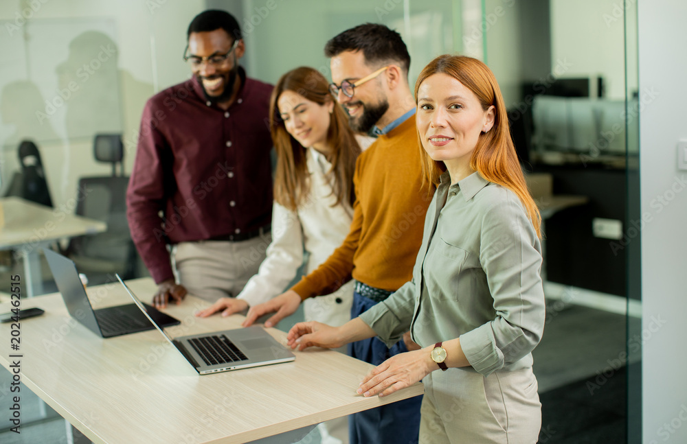 Obraz premium Team members working together on laptops in a modern office space