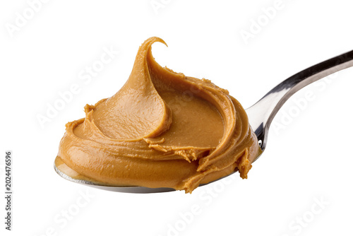 Фотография Isolated creamy peanut butter on a silver spoon with a delicious peak, ideal for