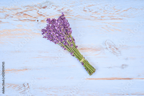 Top view of lavender bouquet on light blue wooden background, rustic floral composition with purple flowers, aromatic herb arrangement and minimal flat lay style with soft pastel tones