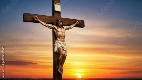 The Crucifixion of Jesus Christ on the Cross against a vibrant sunset